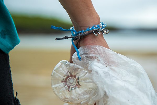 Bracelets on the wrist while collecting plastic on the beach